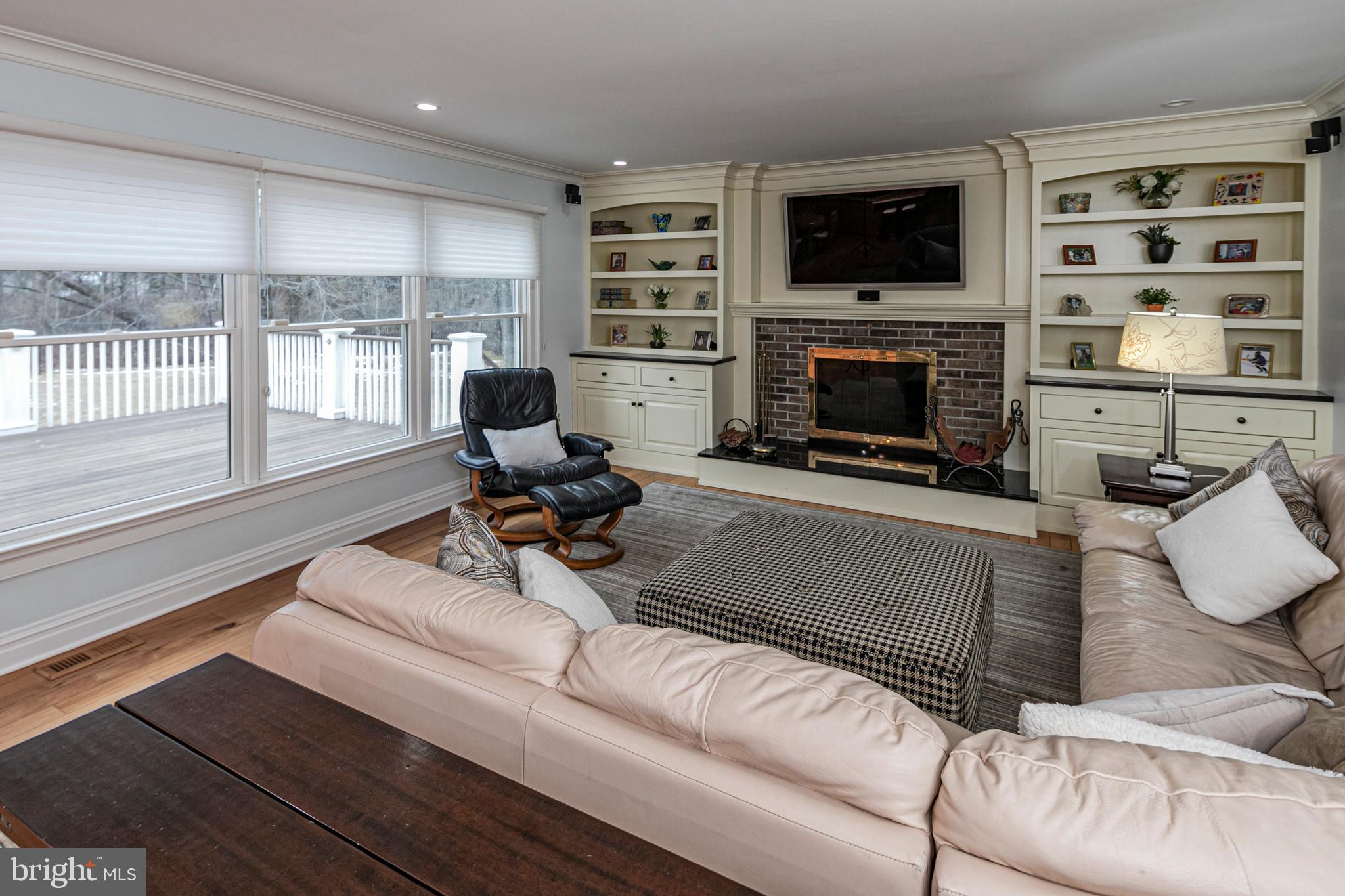 6 Nelson Ridge Road Princeton, NJ 08540 - Photo 20 of 41 a living room with furniture a flat screen tv and a fireplace