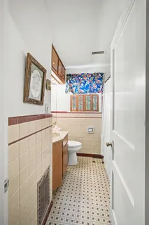 a bathroom with a sink a toilet and a shower