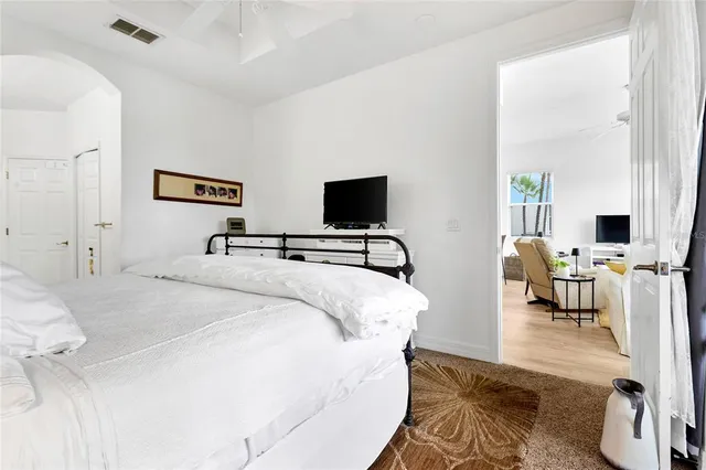 a bedroom with a bed and a flat screen tv