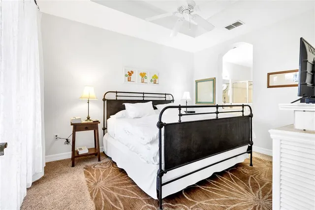 a bedroom with a bed and a desk