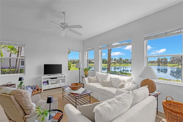 a living room with furniture a window and a flat screen tv