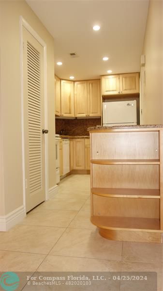a view of kitchen with stainless steel appliances cabinets