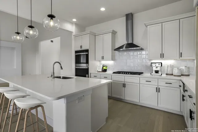 a kitchen with kitchen island white cabinets and refrigerator