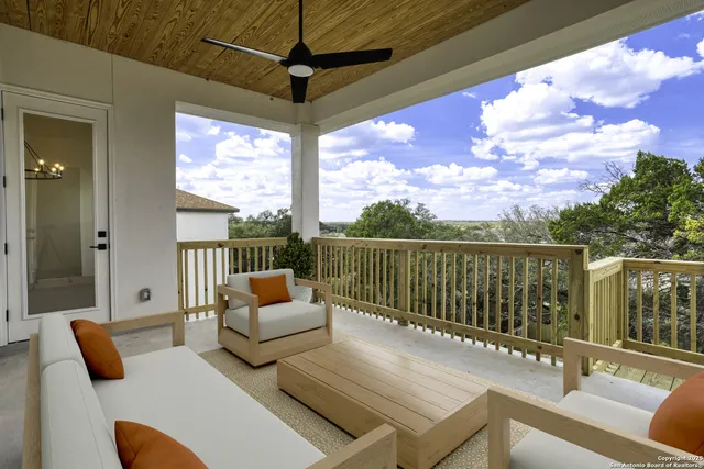 a balcony with table and chairs