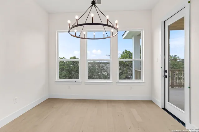 an empty room with windows and outdoor view