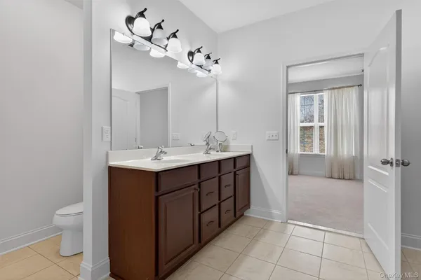 a bathroom with a sink vanity and a mirror