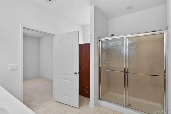 a bathroom with a glass door shower