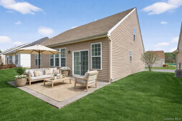 a view of a house with backyard and sitting area