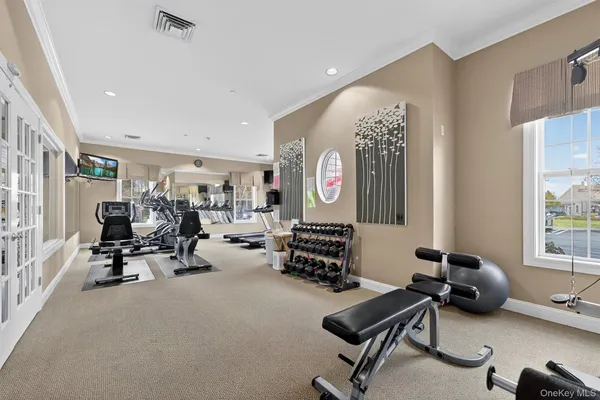 a room with gym equipment and a large window
