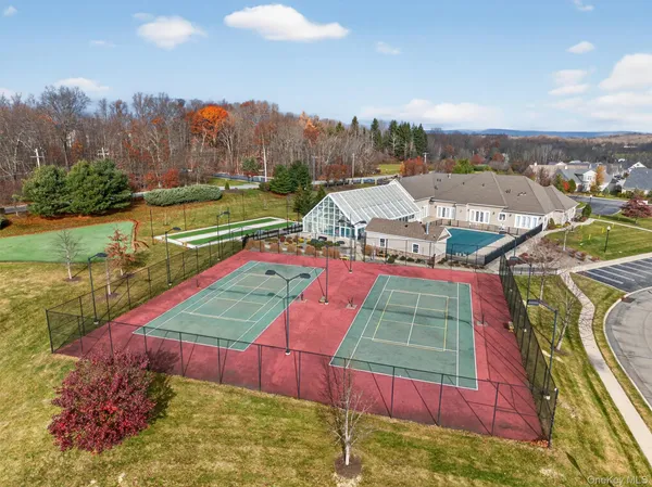 an aerial view of a houses with a swimming pool