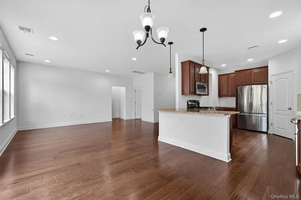a view of kitchen with stainless steel appliances refrigerator stove top oven and refrigerator