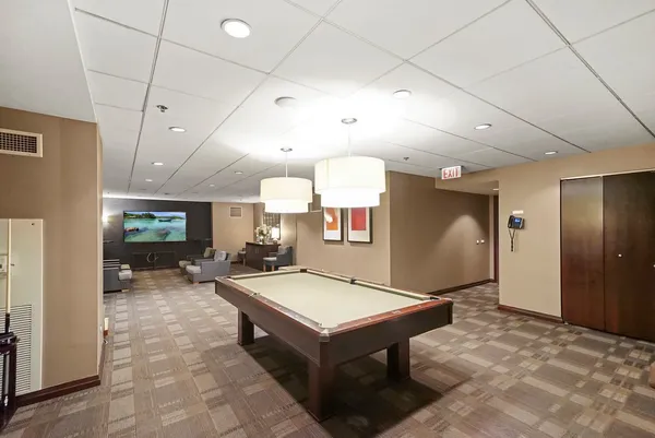 a room with pool table and a couch