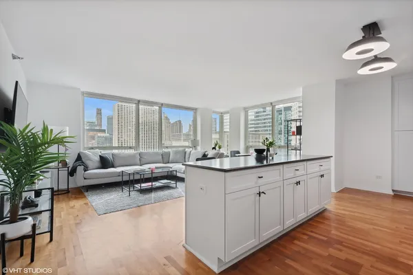 a large living room with granite countertop furniture a couch and a potted plant