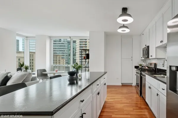 a large kitchen with stainless steel appliances granite countertop a lot of counter space