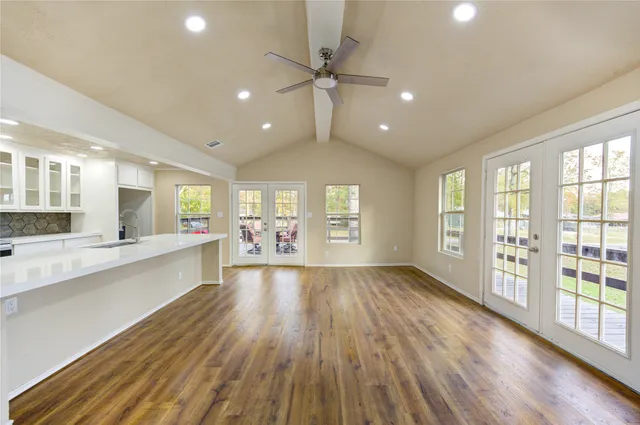 a large kitchen with lot of wooden floor