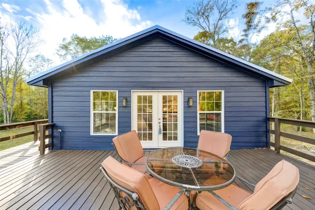 a view of a chairs and table in patio of the house