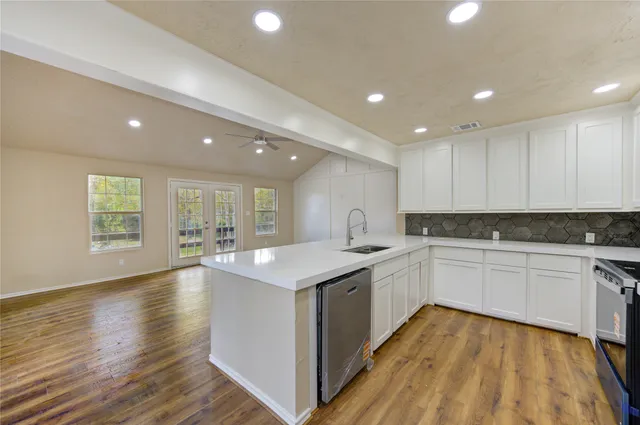 a kitchen with sink and cabinets
