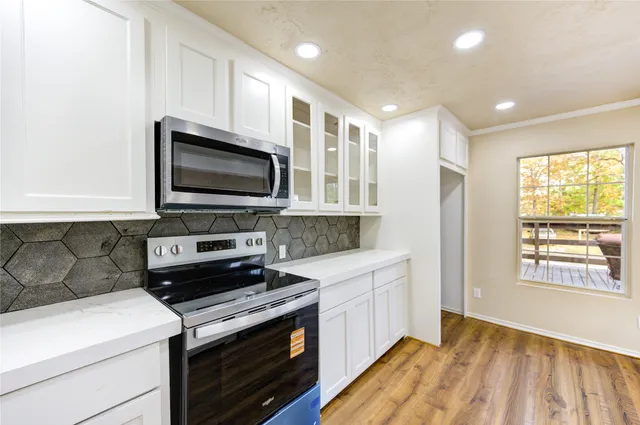 a kitchen with a stove and a microwave