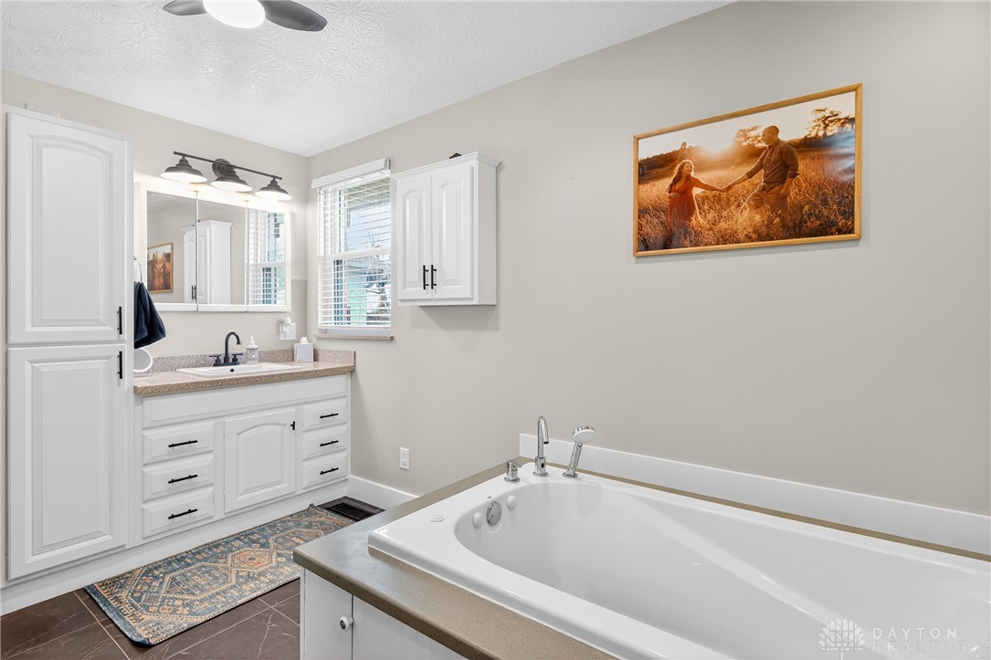 7888 Darke-Preble County Line Road Arcanum, OH 45304 - Photo 29 of 51 This serene bathroom offers a spacious soaking tub and a functional vanity for daily routines.