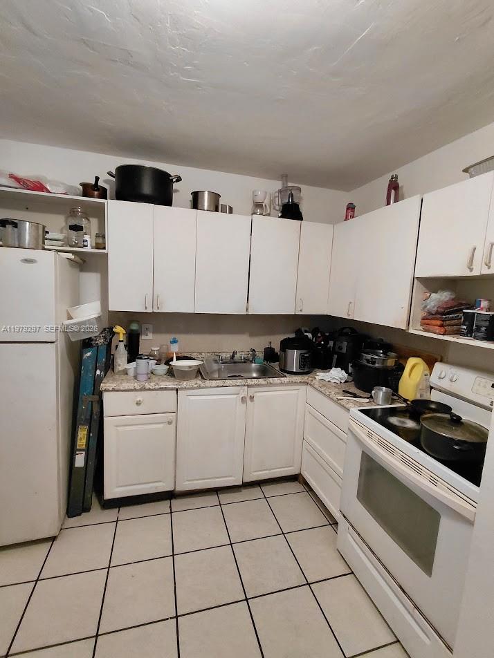 1262 Northwest 46th Street Miami, FL 33142 - Photo 11 of 11 a kitchen with a stove top oven and cabinets
