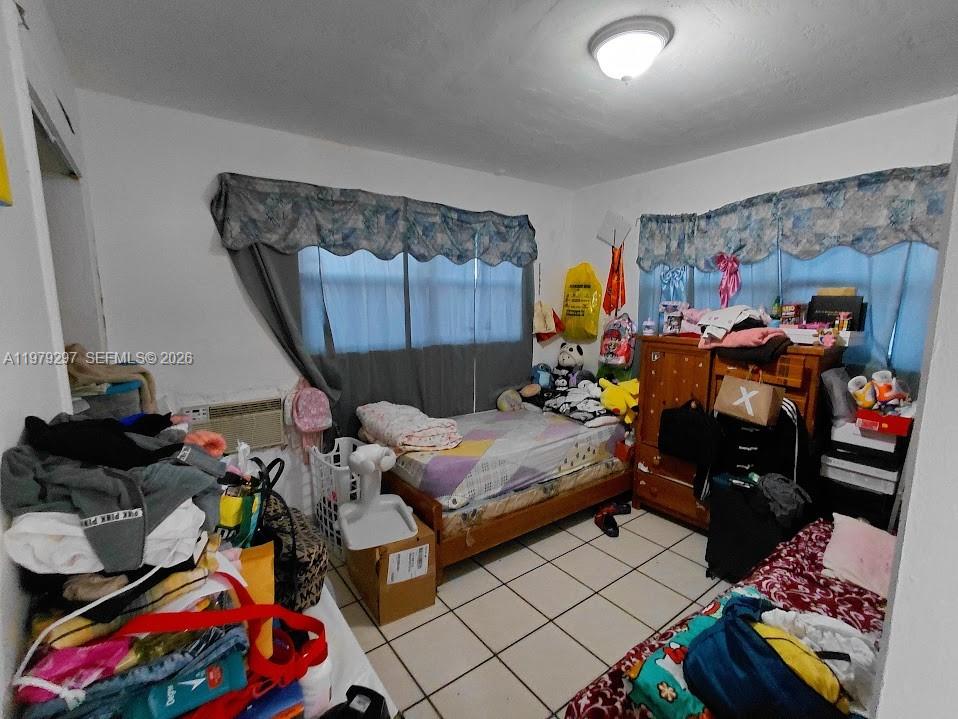 1262 Northwest 46th Street Miami, FL 33142 - Photo 6 of 11 a bed room with furniture and a window