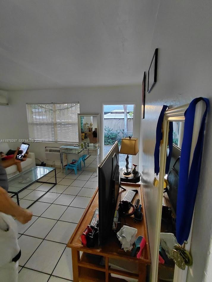 1262 Northwest 46th Street Miami, FL 33142 - Photo 8 of 11 a living room with furniture and a flat screen tv