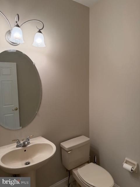 80 Brecknock Court Newtown, PA 18940 - Photo 6 of 22 a bathroom with a toilet a sink and mirror