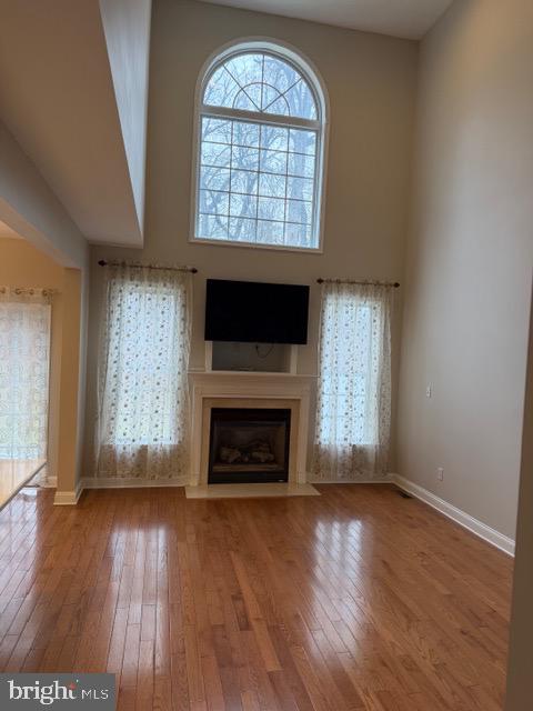80 Brecknock Court Newtown, PA 18940 - Photo 7 of 22 an empty room with wooden floor fireplace and windows