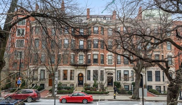 a city street lined with buildings and cars