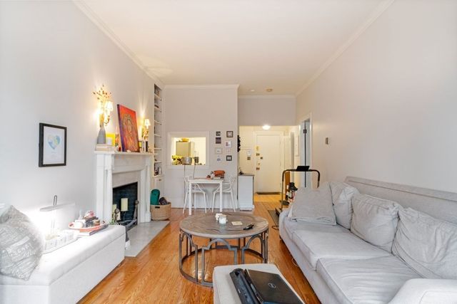 a living room with furniture a fireplace and a table