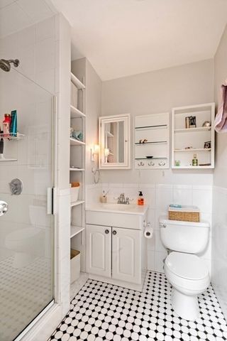 a bathroom with a sink toilet vanity and shower
