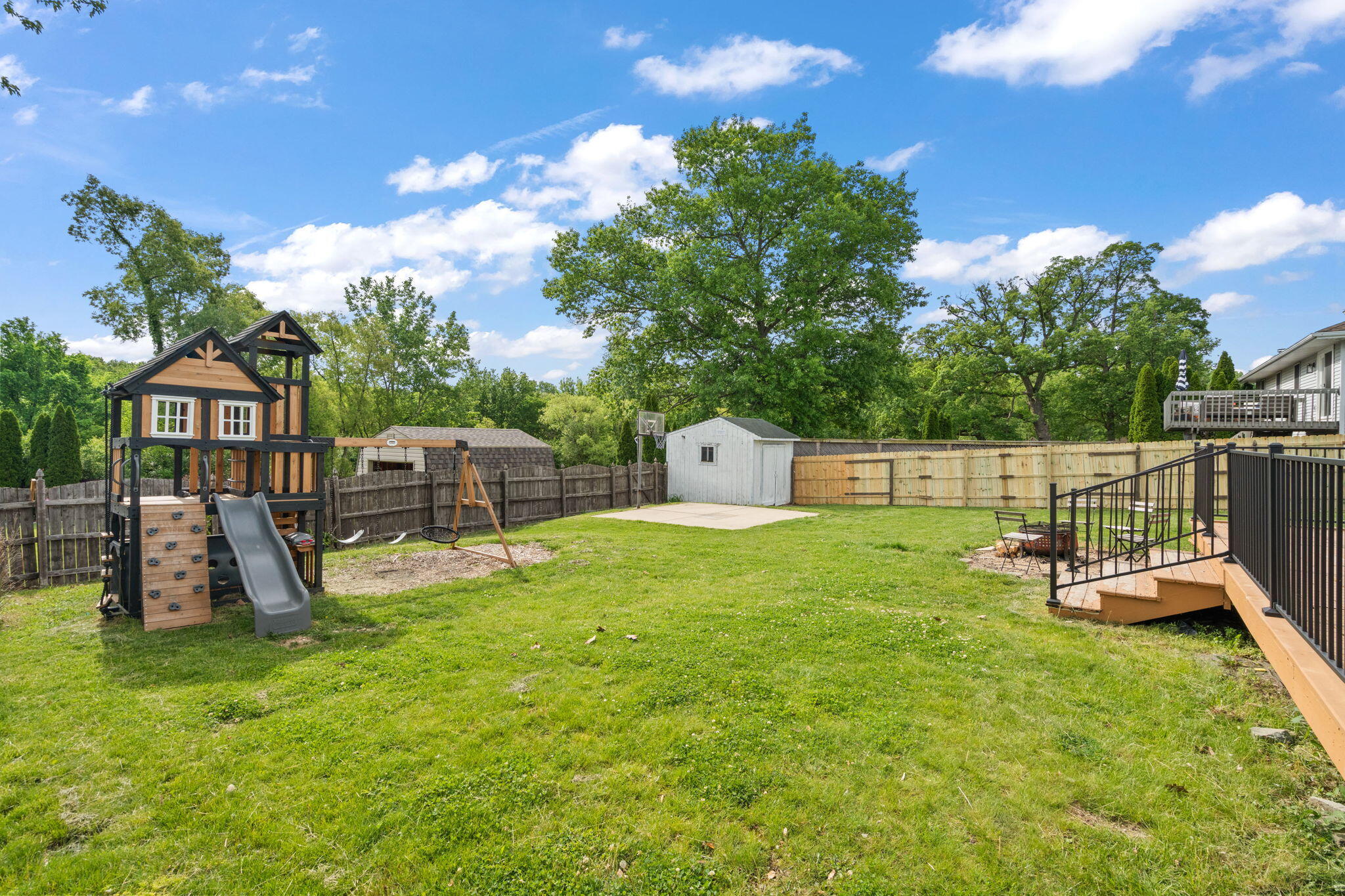 8987 Calhoun Place Crown Point, IN 46307 - Photo 27 of 28 a view of a backyard with a slide