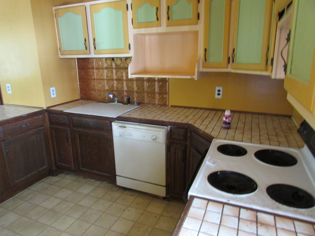 60 Brookfield Road Charlton, MA 01507 - Photo 4 of 14 a kitchen with a sink and a stove next to a window