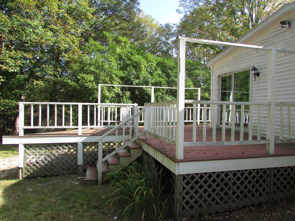 60 Brookfield Road Charlton, MA 01507 - Photo 6 of 14 a view of a deck with a chair