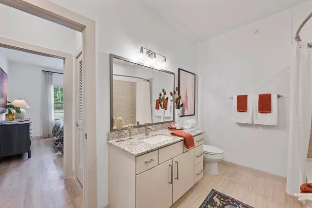 a bathroom with a granite countertop sink mirror and vanity