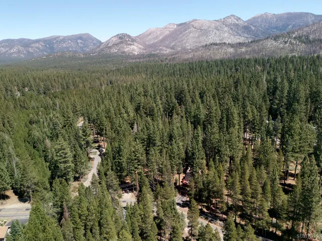 a view of a lush green hillside and a building