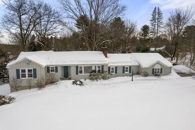 a view of a house with yard and snow