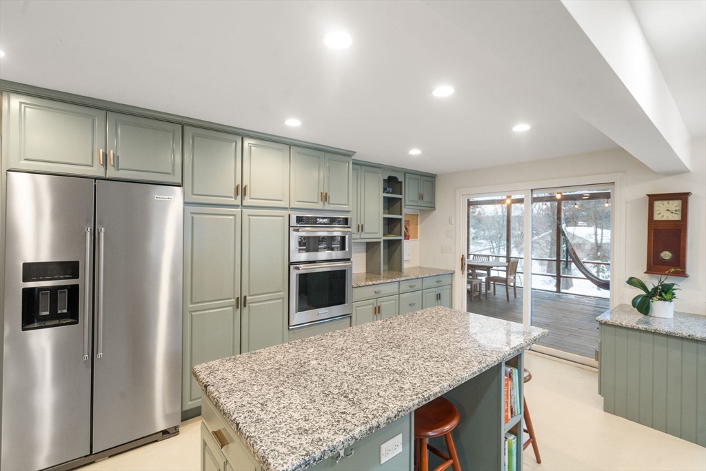 26 Jeffrey Road Wayland, MA 01778 - Photo 11 of 40 a kitchen with stainless steel appliances granite countertop a refrigerator a stove and a sink