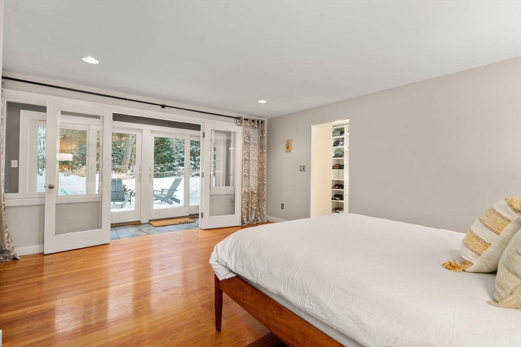 26 Jeffrey Road Wayland, MA 01778 - Photo 16 of 40 a spacious bedroom with a bed and glass door