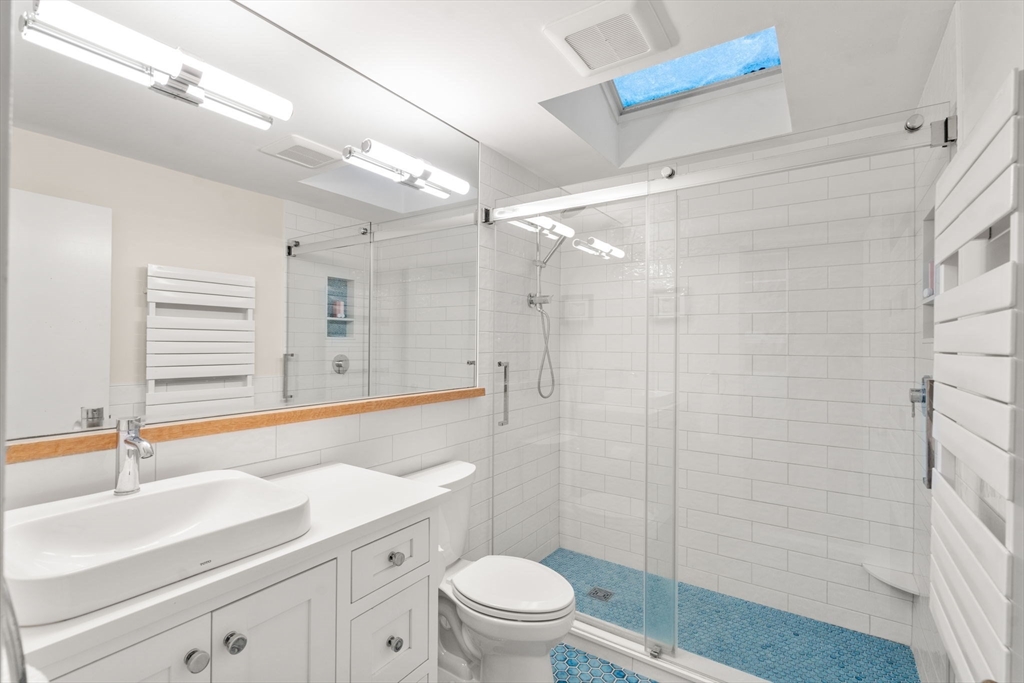 26 Jeffrey Road Wayland, MA 01778 - Photo 17 of 40 a bathroom with a sink a toilet a mirror and shower