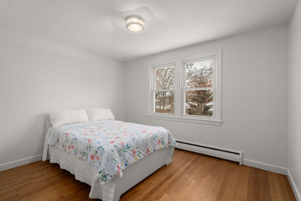 26 Jeffrey Road Wayland, MA 01778 - Photo 22 of 40 a bedroom with a bed lamp and window