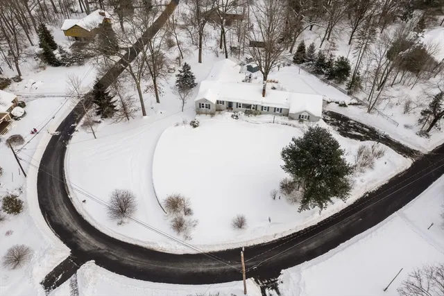 an empty room with wooden floor and large windows