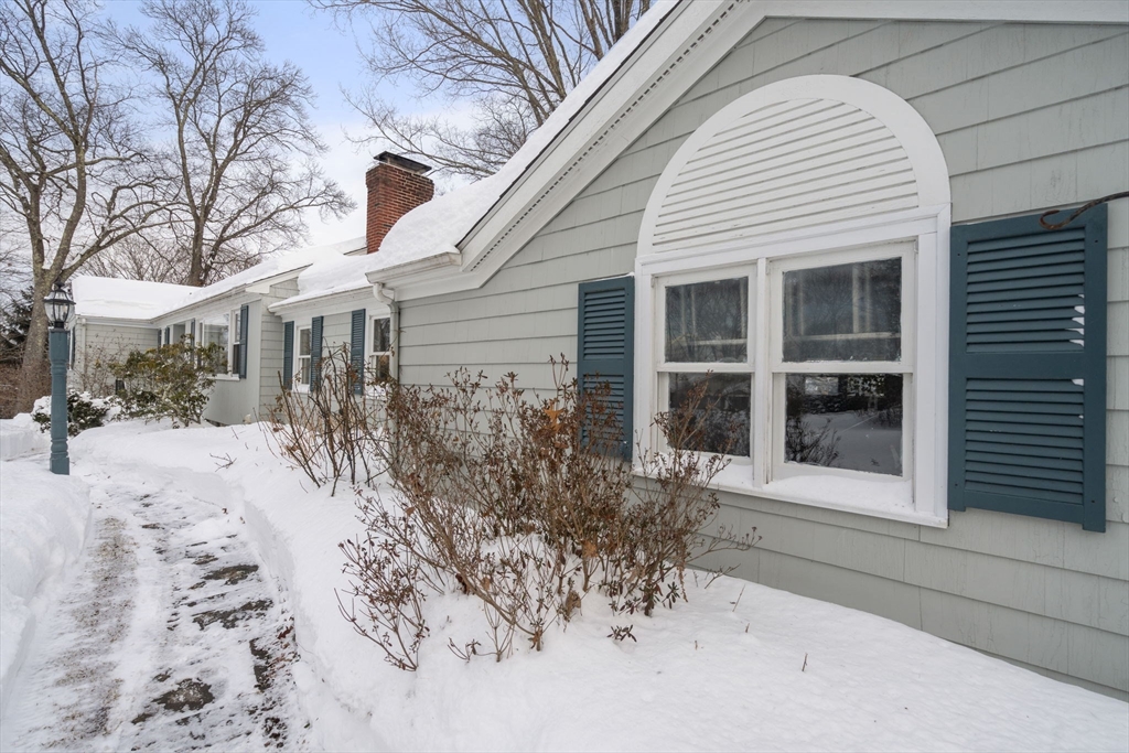 26 Jeffrey Road Wayland, MA 01778 - Photo 36 of 40 a front view of a house with a yard and seating space