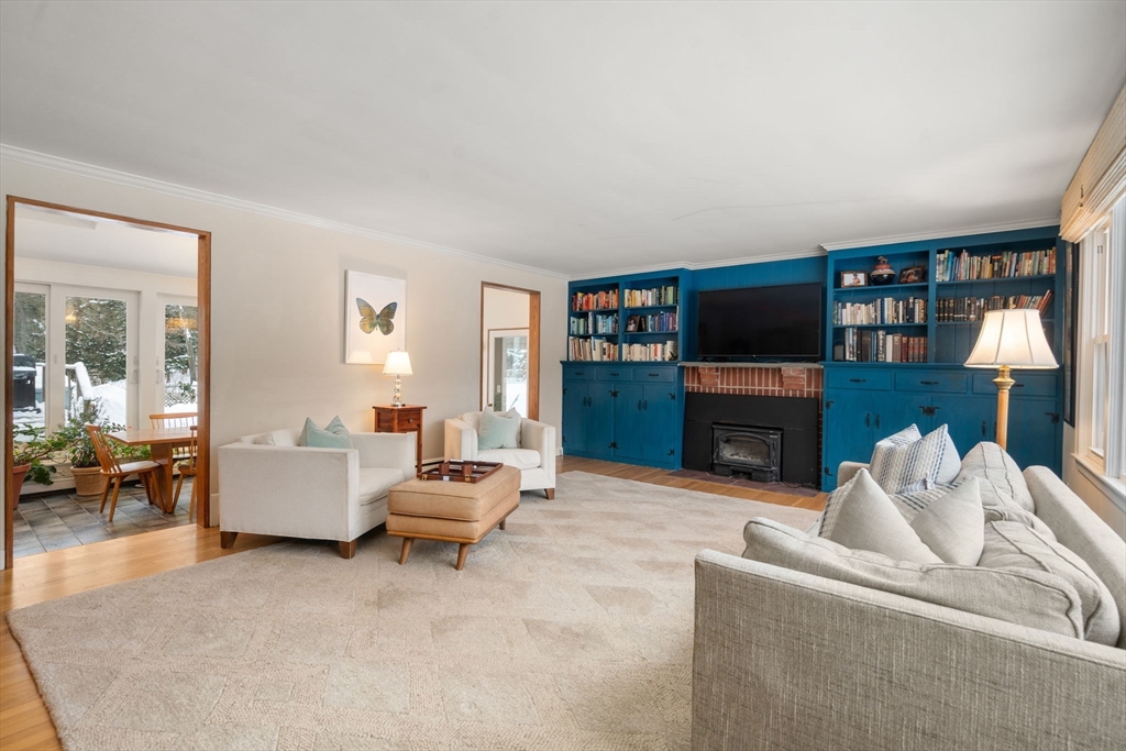 26 Jeffrey Road Wayland, MA 01778 - Photo 5 of 40 a living room with furniture a fireplace and a flat screen tv