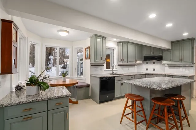a kitchen with granite countertop appliances a sink and cabinets