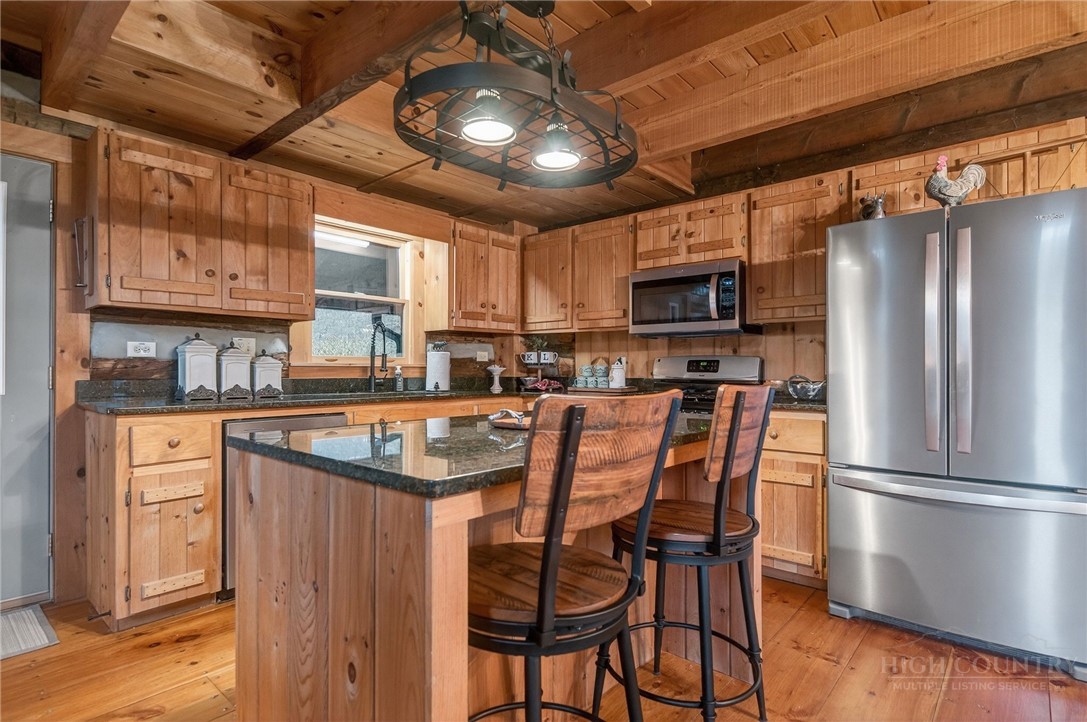 376 Yellow Bear Road Todd, NC 28684 - Photo 8 of 29 a kitchen with stainless steel appliances granite countertop a refrigerator a sink dishwasher a stove and a refrigerator with wooden floor