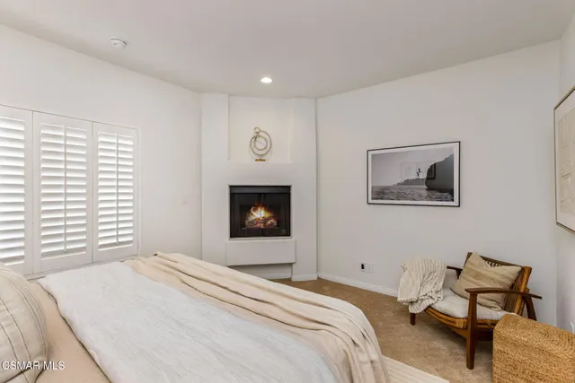 a bedroom with a bed and chair