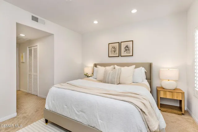 a bedroom with a bed and a lamp