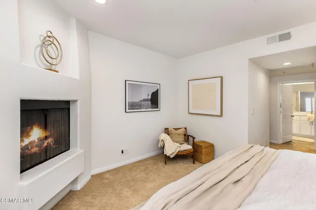 a bedroom with a bed and a painting on the wall