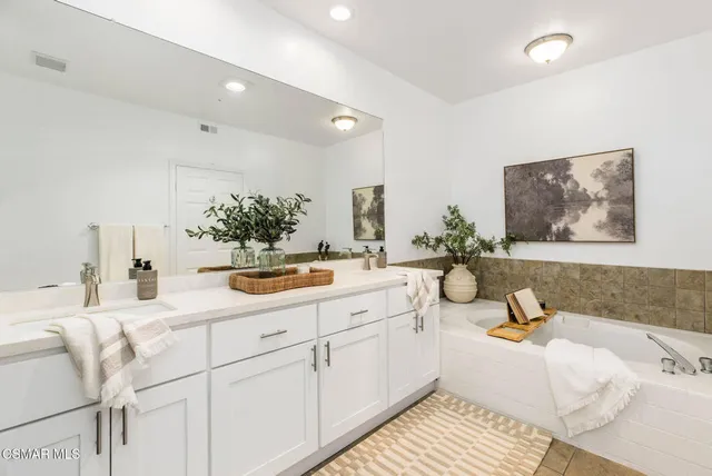 a living room with furniture and a painting